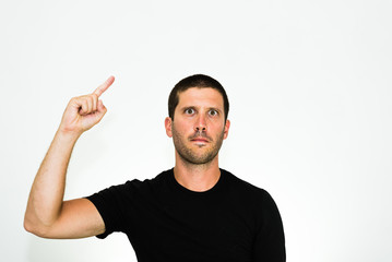 Fototapeta premium close-up of a concentrated young caucasian man raising a finger - isolated on white background