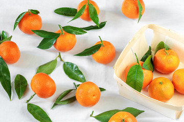 Tangerines on white tablecloth