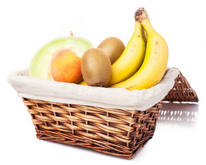 wicker basket with fruit inside on a white background