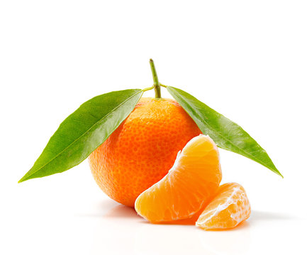 Tangerine with leaves and slices isolated on white background