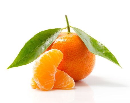 Tangerine with leaves and slices isolated on white background