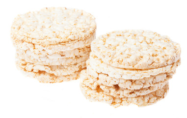 Fototapeta na wymiar two piles of puffed rice snack on a white background