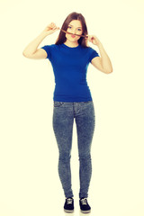 Teenager making moustache from hair.