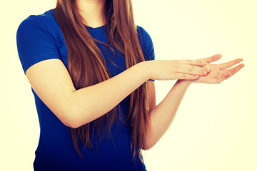 Young happy clapping woman.