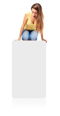 surprised girl looking down sitting on a paper poster