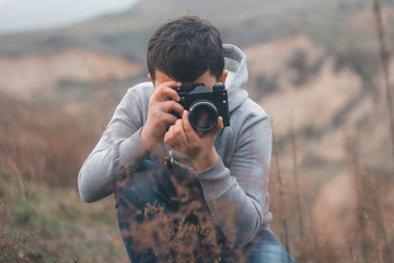 Young boy shooting with vintage camera © krste supev