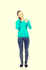 Fototapeta premium Teen with mobile phone and thumbs up.