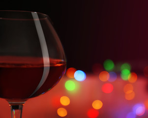 Wine glass with bokeh on dark background