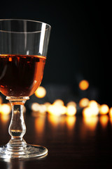 Wine glass with bokeh on dark background