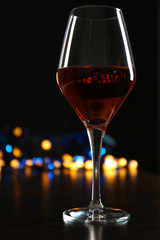 Wine glass with bokeh on dark background