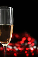 A glass of champagne with bokeh on dark background