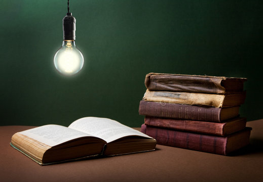 Open book  under the incandescent bulb