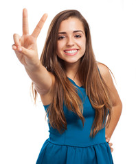 pretty woman doing victory symbol  on white background