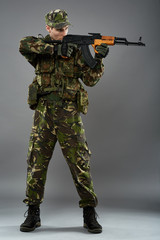 Soldier in uniform with machine gun