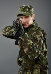 Fototapeta premium Soldier with machine gun aiming