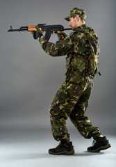 Soldier in uniform with machine gun