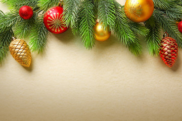 Christmas fir tree branches with toys on paper background