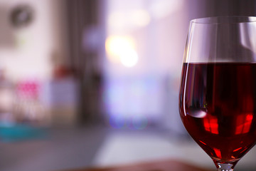 Glass of red wine on blurred background