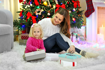 Fototapeta na wymiar Mother with daughter near Christmas tree