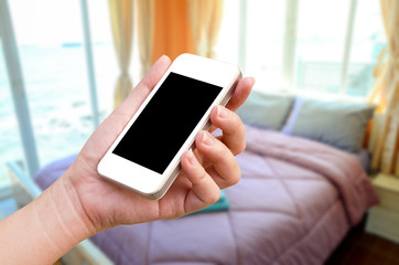 women hand holding the phone tablet on blurry room background