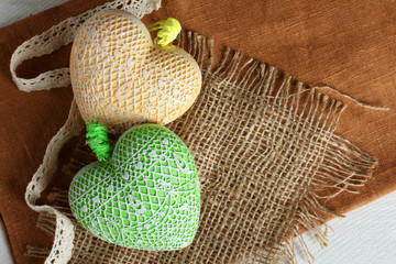 Decorative heart on the fabric on a wooden table