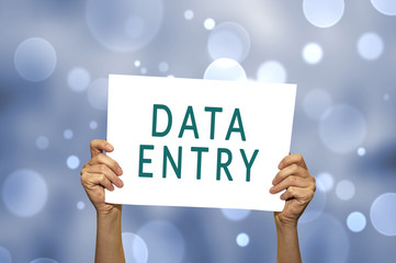 DATA ENTRY card in hand with abstract light background.