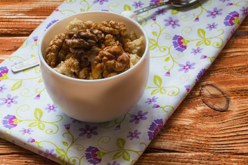 Porridge with cinnamon and walnut in white cup