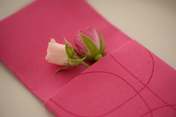 Two beautiful roses in red napkin