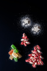 Jelly Christmas trees and sugar stars in the forms for biscuits vertical