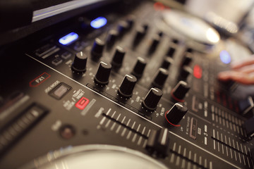 Closeup with DJ equipment with mixer nobs
