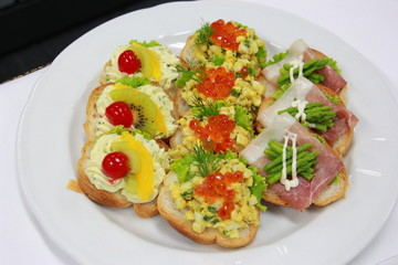 delicious canapes with egg, fish egg, salmon,asparagus and cream cheese
