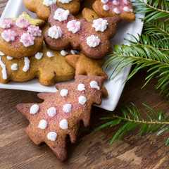 Colorful Christmas gingerbread cookies on wooden background