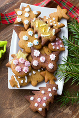 Colorful Christmas gingerbread cookies on wooden background