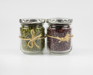 Mung bean and adzuki beans in a mason jar over white background