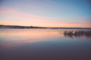 Fototapeta na wymiar Foggy morning on the country lake - vintage effect