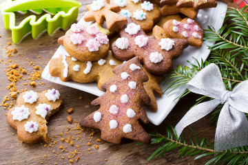 Colorful Christmas gingerbread cookies on wooden background