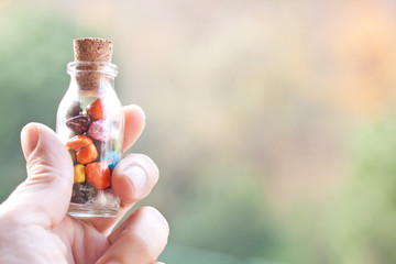 holding a bottle of pebbles candies