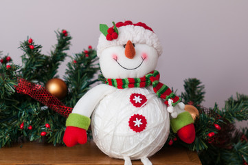 plush chriastmas snowman sitting on a mantle