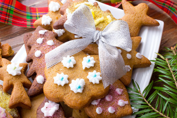 Colorful Christmas gingerbread cookies on wooden background