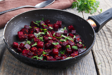 Cooked beets sliced and fried in a pan