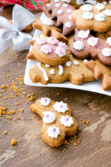Colorful Christmas gingerbread cookies on wooden background