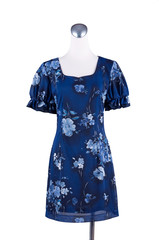 Womens beautiful blue pattern dress on mannequin on white background
