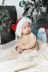 Obraz na płótnie Canvas photo of cute baby in Santa hat