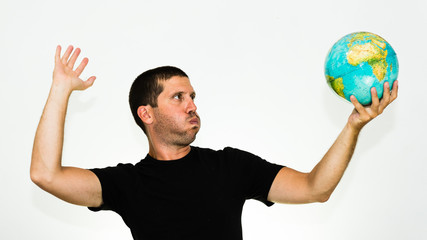 close-up of smiling caucasian man playing volleyball with a world globe - conceptual image isolated on white background