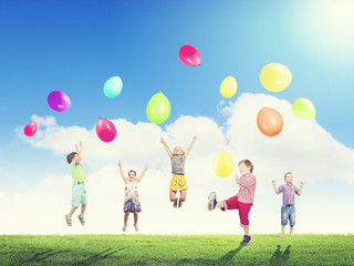 Obraz na płótnie Canvas Playful children catch balloons