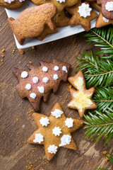 Colorful Christmas gingerbread cookies on wooden background