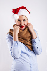 Woman in santa hat. Smiling over white background.