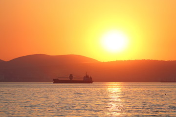 Fototapeta na wymiar Silhouette of a sea vessel at evening light
