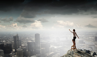 Woman reaching hand up