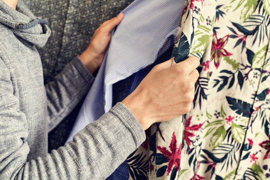 Young Man Choosing A Shirt